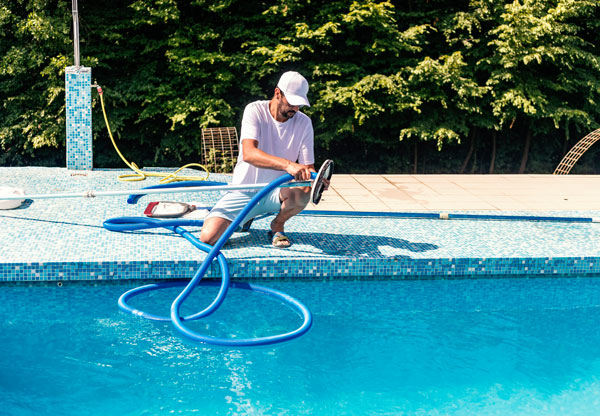 Bridger Spa services tech doing scheduled maintenance on a pool